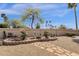 Beautifully landscaped backyard with stone pathway, garden, and mature trees at 19791 N 86Th Dr, Peoria, AZ 85382