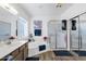 Bright bathroom featuring a soaking tub, a walk-in shower, and a vanity with a sink at 19791 N 86Th Dr, Peoria, AZ 85382
