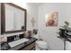 Half bathroom features a granite counter, decorative wall art, and natural light at 19791 N 86Th Dr, Peoria, AZ 85382
