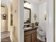 Cozy half bathroom featuring dark countertops, stylish fixtures, and warm neutral paint at 19791 N 86Th Dr, Peoria, AZ 85382