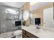 Bathroom featuring a walk-in shower, vanity, and a decorative window at 19791 N 86Th Dr, Peoria, AZ 85382