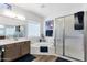 Bright bathroom with a soaking tub, a walk-in shower, and a vanity with a sink at 19791 N 86Th Dr, Peoria, AZ 85382