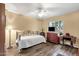 Comfortable bedroom with wood-look floors, ceiling fan, and a window with a view at 19791 N 86Th Dr, Peoria, AZ 85382