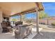 Inviting covered patio with ample seating, overlooking the landscaped yard at 19791 N 86Th Dr, Peoria, AZ 85382