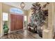 Foyer featuring wood floors, neutral colored walls, lots of light, and a statement tree at 19791 N 86Th Dr, Peoria, AZ 85382