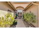 The entryway showcases mature landscaping and a secure front door, complemented by a charming exterior at 19791 N 86Th Dr, Peoria, AZ 85382