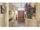 Foyer featuring wood floors, neutral colored walls, lots of light, and a statement tree at 19791 N 86Th Dr, Peoria, AZ 85382
