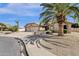 Single story home boasts desert landscaping, a spacious three car garage, and a large palm tree at 19791 N 86Th Dr, Peoria, AZ 85382