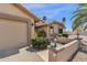 Close up shot of the desert landscaped home's exterior, highlighting the well-maintained garden and neutral color palette at 19791 N 86Th Dr, Peoria, AZ 85382