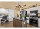 Kitchen view featuring stainless appliances, white cabinets, and a kitchen island at 19791 N 86Th Dr, Peoria, AZ 85382