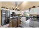 Kitchen featuring granite counters, an island, stainless steel appliances and ample cabinetry at 19791 N 86Th Dr, Peoria, AZ 85382