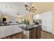 Well-lit eat-in kitchen with wood floors, a center island, and a desk area at 19791 N 86Th Dr, Peoria, AZ 85382