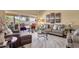 Bright living room showcasing wood floors, neutral walls, comfortable seating, and outdoor patio access at 19791 N 86Th Dr, Peoria, AZ 85382