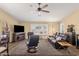 Open living room with wood flooring and large windows providing natural light at 19791 N 86Th Dr, Peoria, AZ 85382