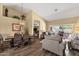 Open-concept living room featuring hardwood floors, neutral colored walls, lots of light, and adjacent dining room at 19791 N 86Th Dr, Peoria, AZ 85382