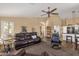 Cozy living room featuring wood floors, a ceiling fan, and a neutral color palette at 19791 N 86Th Dr, Peoria, AZ 85382