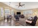 Spacious living room with vaulted ceilings, plantation shutters, and wood-look flooring at 19791 N 86Th Dr, Peoria, AZ 85382