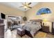 Main bedroom with patio access, high ceilings, and a well-appointed en-suite bathroom at 19791 N 86Th Dr, Peoria, AZ 85382