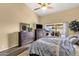 Primary bedroom with wood-look floors, plenty of dresser storage, and a sliding glass door to the patio at 19791 N 86Th Dr, Peoria, AZ 85382