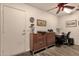 A home office featuring wood-look floors, a desk, storage, and a ceiling fan at 19791 N 86Th Dr, Peoria, AZ 85382