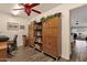 A home office space includes wooden storage, a desk area, and comfortable seating at 19791 N 86Th Dr, Peoria, AZ 85382