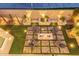 Aerial view of a backyard featuring a modern fire pit and ample seating and soft lighting at 21073 W Sunrise Ln, Buckeye, AZ 85396