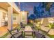 Backyard with fire pit, outdoor seating, and beautifully landscaped planters at 21073 W Sunrise Ln, Buckeye, AZ 85396
