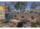 Inviting backyard with a cozy fire pit, stylish seating, manicured landscaping, and privacy wall at 21073 W Sunrise Ln, Buckeye, AZ 85396