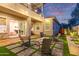 Backyard patio featuring a fire pit, seating, and an outdoor cooking area at 21073 W Sunrise Ln, Buckeye, AZ 85396