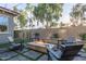 Inviting backyard with a modern fire pit and ample seating for outdoor entertaining at 21073 W Sunrise Ln, Buckeye, AZ 85396