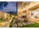 Twilight view of backyard featuring a fire pit and exterior lighting at 21073 W Sunrise Ln, Buckeye, AZ 85396