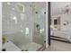 This bathroom features a large tiled shower with mosaic tile, a bench, and glass doors at 21073 W Sunrise Ln, Buckeye, AZ 85396