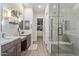 This bathroom has a large, tiled shower with a built-in bench, a tiled floor, and and sinks at 21073 W Sunrise Ln, Buckeye, AZ 85396