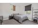 This bedroom features a full-sized bed, shelving, and lots of natural light from the window at 21073 W Sunrise Ln, Buckeye, AZ 85396