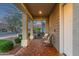 Inviting front porch with comfortable seating, complemented by lush landscaping at 21073 W Sunrise Ln, Buckeye, AZ 85396