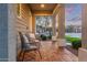 Charming front porch with stylish chairs, perfect for relaxing and enjoying the neighborhood at 21073 W Sunrise Ln, Buckeye, AZ 85396