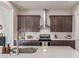 Bright kitchen featuring stainless steel appliances, subway tile backsplash, and a large center island at 21073 W Sunrise Ln, Buckeye, AZ 85396