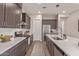 Modern kitchen features stainless appliances, white countertops, and wood-look floors for a sleek, contemporary design at 21073 W Sunrise Ln, Buckeye, AZ 85396