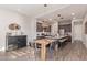 Modern kitchen with stainless steel appliances, center island seating, and an adjacent dining area at 21073 W Sunrise Ln, Buckeye, AZ 85396