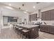 Open kitchen featuring a large island with seating, modern appliances, and sleek cabinetry at 21073 W Sunrise Ln, Buckeye, AZ 85396