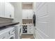 Well-organized laundry room with modern washer and dryer, plus storage at 21073 W Sunrise Ln, Buckeye, AZ 85396