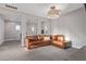 Spacious living room with a comfortable sectional sofa, modern lighting, and open layout design at 21073 W Sunrise Ln, Buckeye, AZ 85396