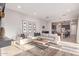 Bright living room featuring an open layout, stylish decor, and seamless flow into the kitchen at 21073 W Sunrise Ln, Buckeye, AZ 85396
