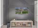 Modern living room featuring an accent wall, entertainment center, and a television displaying an exterior elevation at 21073 W Sunrise Ln, Buckeye, AZ 85396