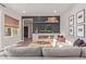 Stylish living room featuring a tiled fireplace, mounted TV and comfortable seating area at 21073 W Sunrise Ln, Buckeye, AZ 85396