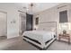 Spacious main bedroom with natural light, sliding barn door into the bath, and modern lighting fixture at 21073 W Sunrise Ln, Buckeye, AZ 85396
