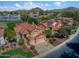Aerial view of a red-roofed home with manicured lawns, mature trees, and a picturesque neighborhood at 21538 N 59Th Ln, Glendale, AZ 85308