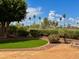 Charming backyard featuring green lawn, brick patio, and well-maintained landscaping offering a serene outdoor space at 21538 N 59Th Ln, Glendale, AZ 85308
