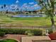 Scenic backyard view overlooking a lake, lush golf course, and well-maintained landscaping at 21538 N 59Th Ln, Glendale, AZ 85308