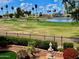 Scenic backyard view overlooking a lake, lush golf course, and well-maintained landscaping at 21538 N 59Th Ln, Glendale, AZ 85308